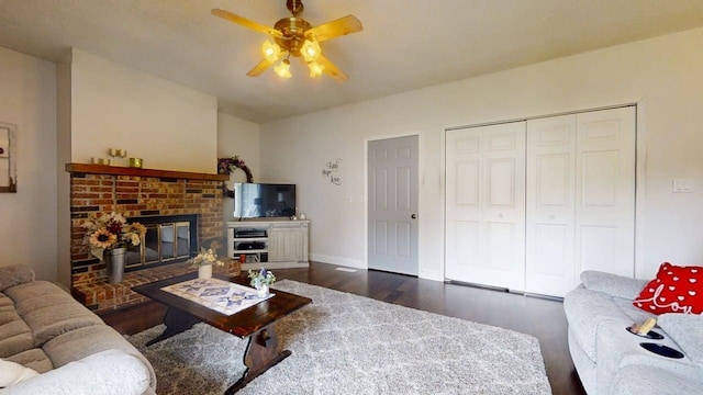 2702 Worcester Dr, Champaign, IL 61821 - living area with dark wood-style floors, ceiling fan, baseboards, and a brick fireplace