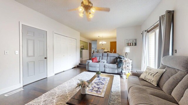 2702 Worcester Dr, Champaign, IL 61821 - living room with a chandelier, dark wood finished floors, a ceiling fan, and baseboards