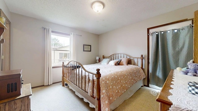 2702 Worcester Dr, Champaign, IL 61821 - bedroom with light colored carpet, a textured ceiling, and baseboards
