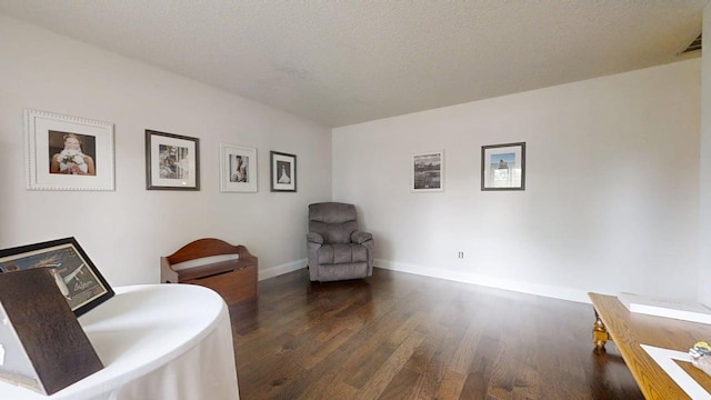 2702 Worcester Dr, Champaign, IL 61821 - sitting room featuring dark wood-type flooring, baseboards, and a textured ceiling