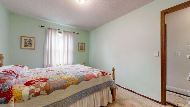2702 Worcester Dr, Champaign, IL 61821 - carpeted bedroom featuring baseboards and a textured ceiling