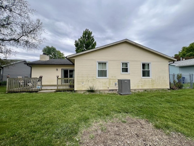 2702 Worcester Dr, Champaign, IL 61821 - rear view of property with central AC unit, a deck, a yard, and a chimney