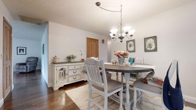 2702 Worcester Dr, Champaign, IL 61821 - dining area featuring dark wood-style flooring, a chandelier, and baseboards