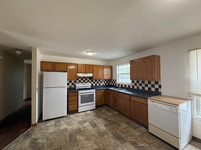 123 E Washington St, Round Lake Park, IL 60073 - kitchen with white appliances, decorative backsplash, a sink, and brown cabinets
