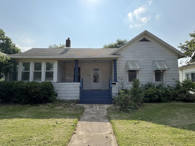 908 N Park St, Streator, IL 61364 - bungalow-style house with a chimney, a front lawn, and a porch