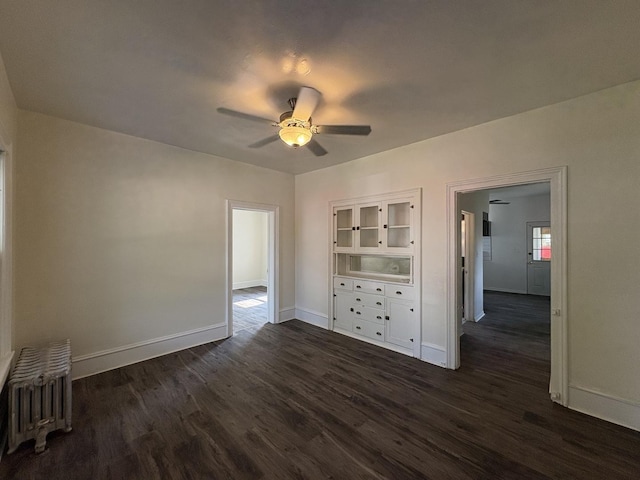 908 N Park St, Streator, IL 61364 - spare room featuring radiator, a ceiling fan, dark wood finished floors, and baseboards