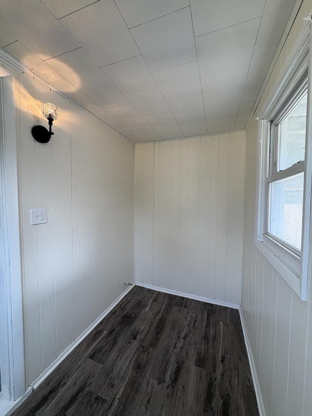 908 N Park St, Streator, IL 61364 - unfurnished room featuring dark wood-style flooring, baseboards, and wood walls