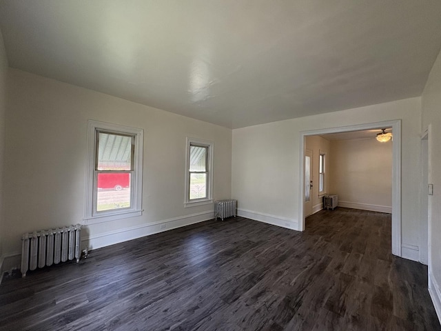 908 N Park St, Streator, IL 61364 - unfurnished room with radiator, dark wood-style flooring, and baseboards