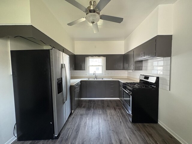 908 N Park St, Streator, IL 61364 - kitchen featuring appliances with stainless steel finishes, dark wood-type flooring, backsplash, a sink, and light countertops
