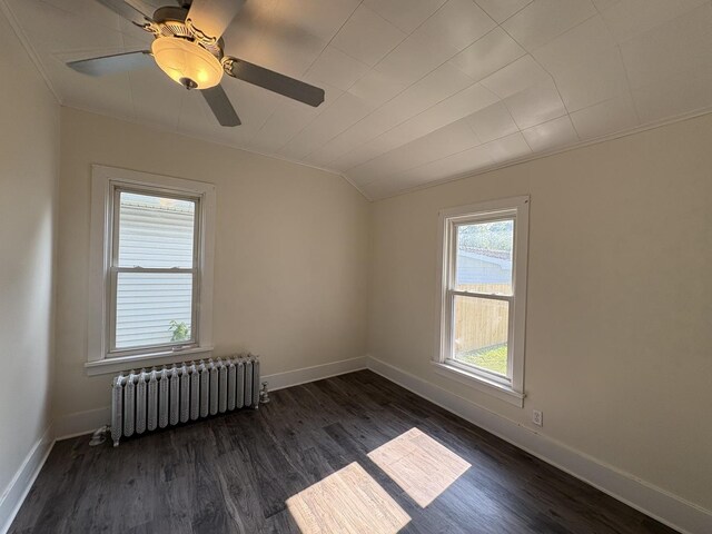 908 N Park St, Streator, IL 61364 - empty room with radiator heating unit, vaulted ceiling, dark wood-type flooring, baseboards, and ornamental molding