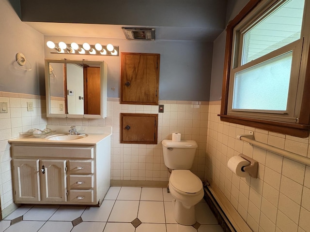 1515 Johnson St, Ottawa, IL 61350 - bathroom featuring toilet, vanity, tile walls, wainscoting, and tile patterned floors