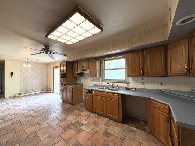 1515 Johnson St, Ottawa, IL 61350 - kitchen featuring a sink, a baseboard heating unit, decorative backsplash, under cabinet range hood, and a chandelier