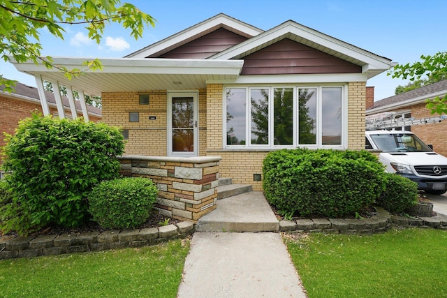 11400 S Hamlin Ave, Chicago, IL 60655 - view of front of house with brick siding, a porch, and a front lawn