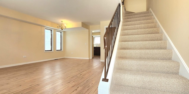2338 S Canal St Unit H, Chicago, IL 60616 - stairway with a chandelier, wood finished floors, and baseboards