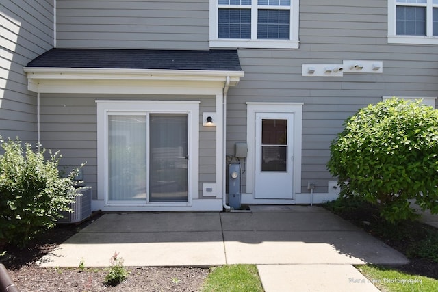 1218 Mariemont Rd Unit C, Sugar Grove, IL 60554 - entrance to property with a patio area, central AC unit, and roof with shingles