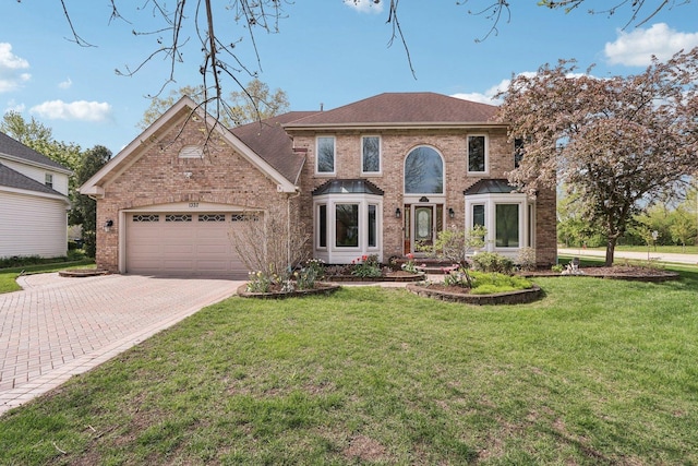 1337 E Thacker St, Schaumburg, IL 60173 - view of front of home featuring brick siding, driveway, a garage, and a front lawn