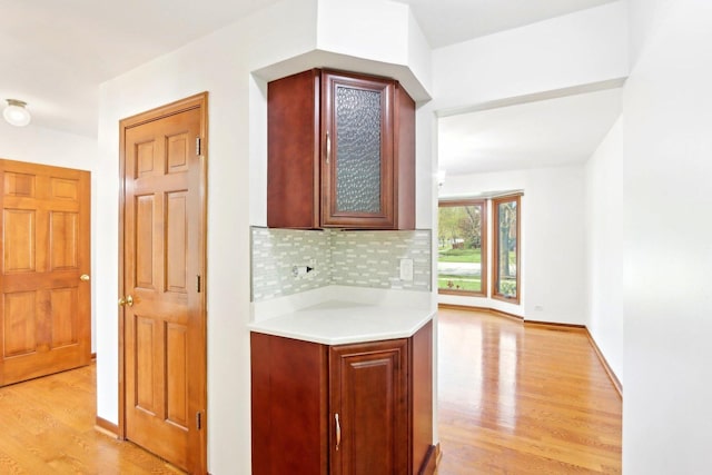 1337 E Thacker St, Schaumburg, IL 60173 - kitchen with light countertops, light wood-style floors, tasteful backsplash, and glass insert cabinets