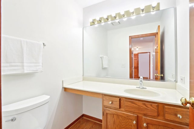 1337 E Thacker St, Schaumburg, IL 60173 - bathroom with vanity, toilet, wood finished floors, and baseboards