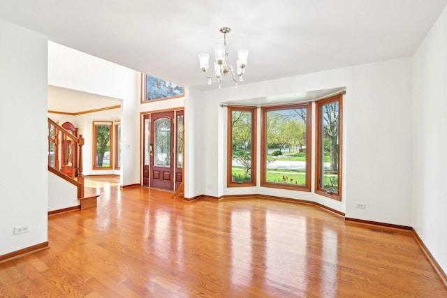 1337 E Thacker St, Schaumburg, IL 60173 - foyer entrance with a chandelier, stairs, wood finished floors, and baseboards