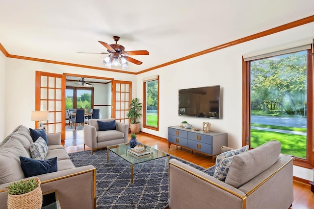 1337 E Thacker St, Schaumburg, IL 60173 - living area with healthy amount of natural light, wood finished floors, ornamental molding, a ceiling fan, and french doors