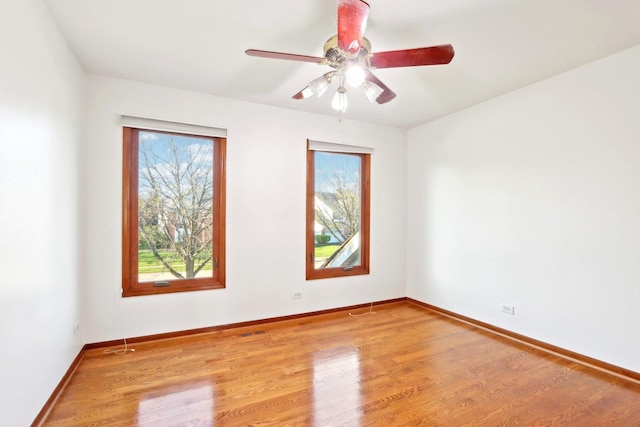 1337 E Thacker St, Schaumburg, IL 60173 - empty room featuring wood finished floors, baseboards, and a ceiling fan