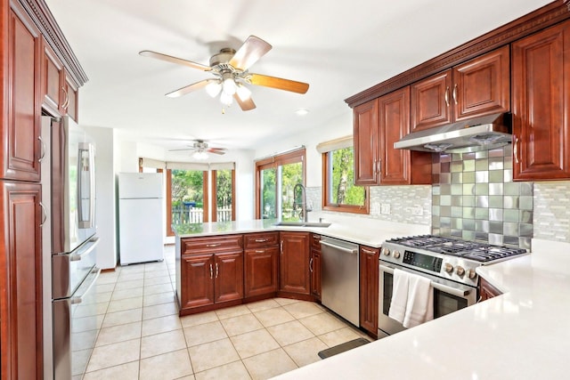1337 E Thacker St, Schaumburg, IL 60173 - kitchen with stainless steel appliances, under cabinet range hood, a sink, backsplash, and light countertops