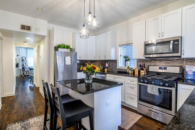 2512 N Marshfield Ave, Chicago, IL 60614 - kitchen featuring stainless steel appliances, tasteful backsplash, white cabinets, and dark wood-type flooring