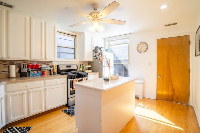 2512 N Marshfield Ave, Chicago, IL 60614 - kitchen featuring gas range, freestanding refrigerator, light wood-style flooring, plenty of natural light, and recessed lighting
