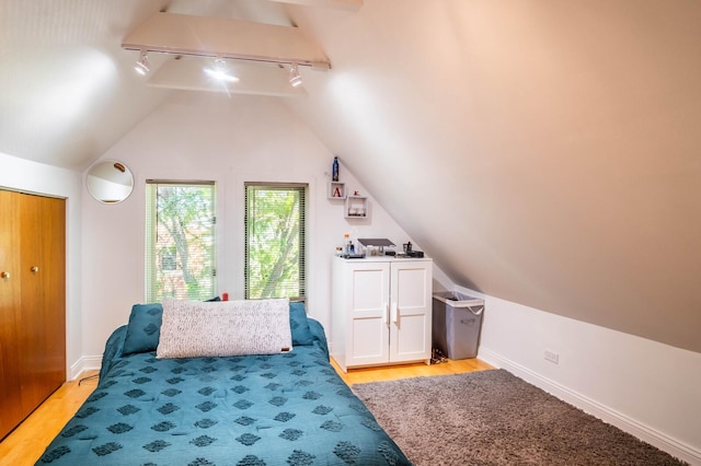 2512 N Marshfield Ave, Chicago, IL 60614 - bedroom with track lighting, light wood-type flooring, vaulted ceiling, and baseboards