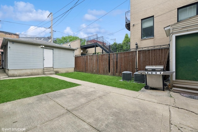 2512 N Marshfield Ave, Chicago, IL 60614 - view of patio with entry steps, central air condition unit, and grilling area