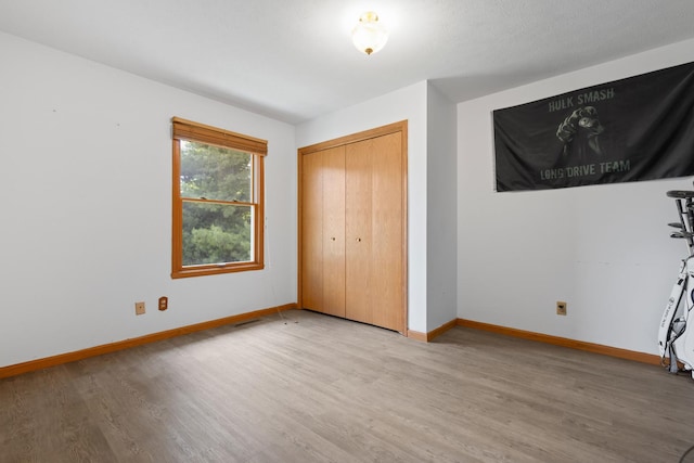 3739 Applewood Ln, Rockford, IL 61114 - unfurnished bedroom featuring wood finished floors, baseboards, and a closet