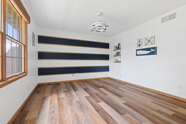 3739 Applewood Ln, Rockford, IL 61114 - spare room with a chandelier, baseboards, and wood finished floors