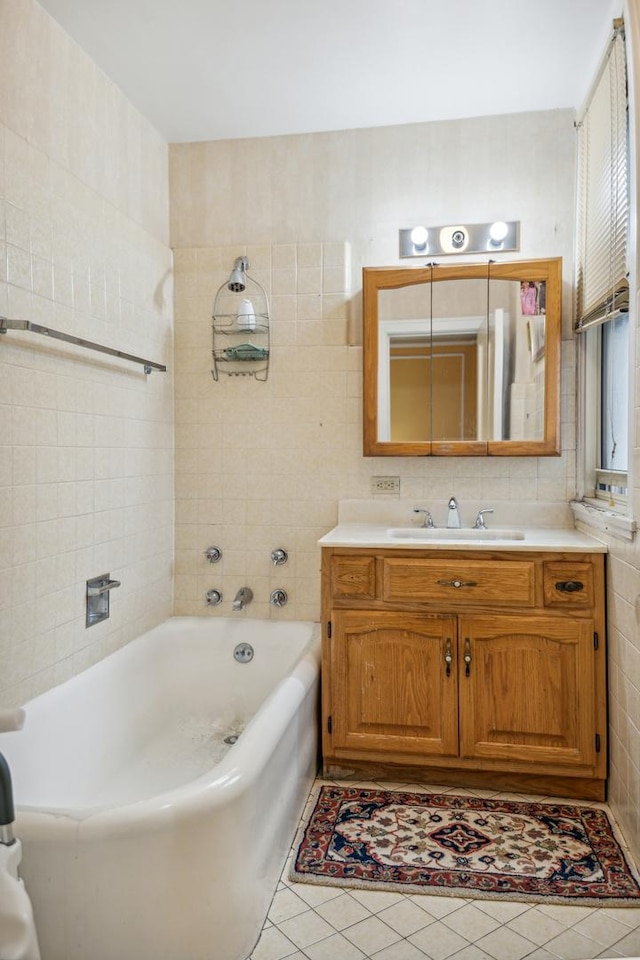 5000 S E End Ave Unit 13A, Chicago, IL 60615 - bathroom featuring tile walls, tile patterned flooring, a tub to relax in, and vanity