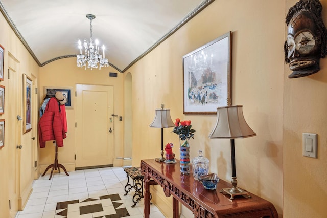 5000 S E End Ave Unit 13A, Chicago, IL 60615 - entrance foyer featuring ornamental molding, light tile patterned flooring, arched walkways, a chandelier, and vaulted ceiling