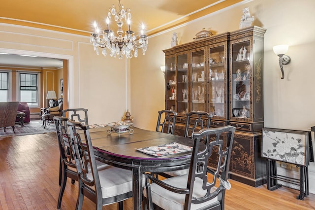5000 S E End Ave Unit 13A, Chicago, IL 60615 - dining space featuring ornamental molding, a chandelier, and light wood finished floors
