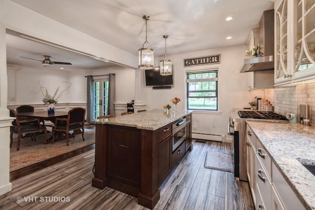 723 Gardner Rd, Flossmoor, IL 60422 - kitchen with appliances with stainless steel finishes, dark brown cabinetry, a baseboard heating unit, decorative backsplash, and recessed lighting