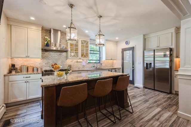 723 Gardner Rd, Flossmoor, IL 60422 - kitchen featuring stainless steel fridge with ice dispenser, wall chimney range hood, a center island, backsplash, and dark wood-style flooring