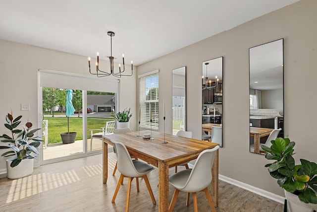 315 Maryland Ln, Pingree Grove, IL 60140 - dining area featuring a chandelier, light wood finished floors, and baseboards