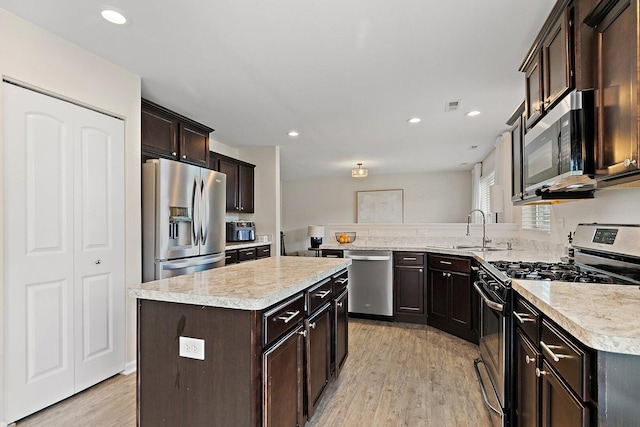 315 Maryland Ln, Pingree Grove, IL 60140 - kitchen with appliances with stainless steel finishes, a sink, light countertops, light wood-style floors, and dark brown cabinets