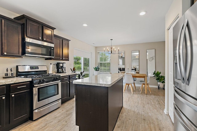 315 Maryland Ln, Pingree Grove, IL 60140 - kitchen with appliances with stainless steel finishes, a chandelier, light wood-style flooring, a kitchen island, and recessed lighting