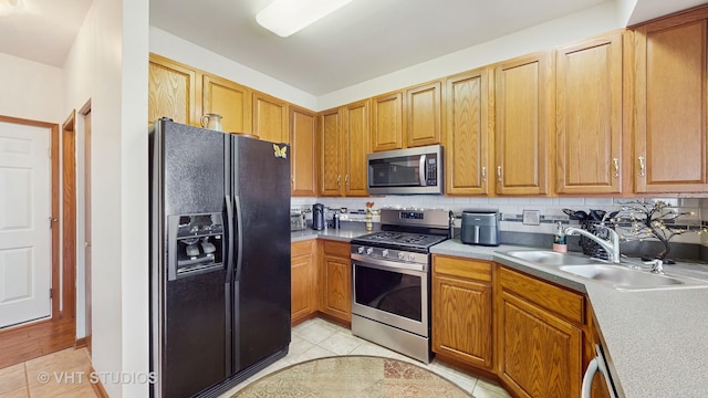 105 Grandview Ct, Volo, IL 60020 - kitchen with appliances with stainless steel finishes, a sink, light tile patterned floors, and light countertops