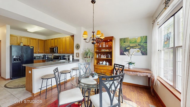 105 Grandview Ct, Volo, IL 60020 - kitchen featuring appliances with stainless steel finishes, a chandelier, healthy amount of natural light, and a peninsula