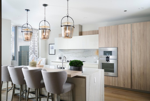 363 E Wacker Dr Unit 6106, Chicago, IL 60601 - kitchen with decorative backsplash, double oven, modern cabinets, and light countertops