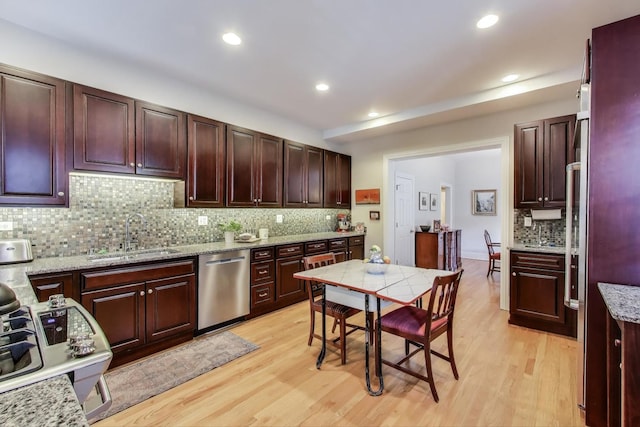 5484 S Hyde Park Blvd, Chicago, IL 60615 - kitchen featuring stainless steel dishwasher, a sink, decorative backsplash, light wood-style flooring, and recessed lighting
