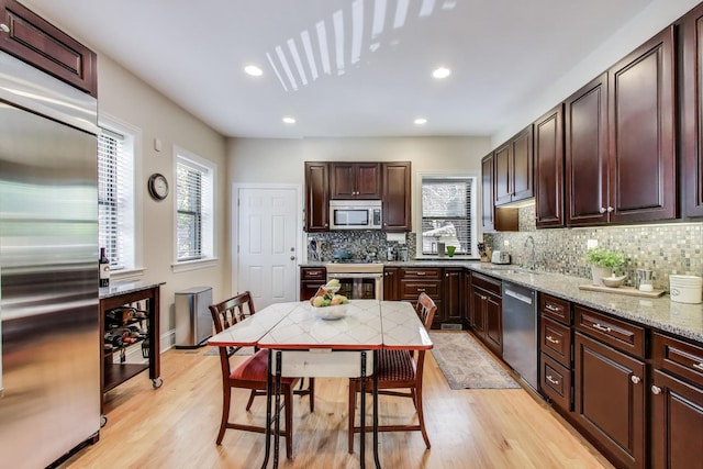 5484 S Hyde Park Blvd, Chicago, IL 60615 - kitchen featuring stainless steel appliances, plenty of natural light, tasteful backsplash, light wood-type flooring, and recessed lighting