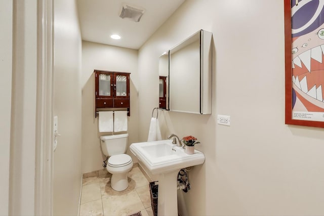 5484 S Hyde Park Blvd, Chicago, IL 60615 - half bathroom with toilet, baseboards, tile patterned floors, and a sink