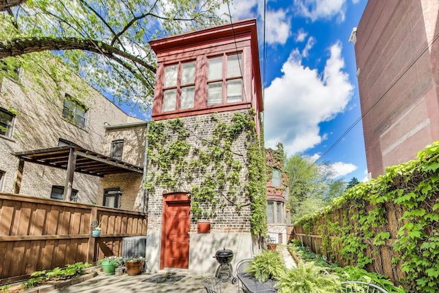 5484 S Hyde Park Blvd, Chicago, IL 60615 - back of house featuring a fenced backyard and brick siding