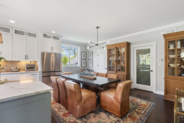 589 Quassey Ave, Lake Bluff, IL 60044 - dining space with a chandelier, dark wood-style floors, recessed lighting, ornamental molding, and baseboards