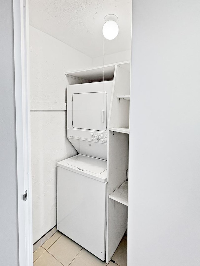 505 N Lake Shore Dr Unit 4105, Chicago, IL 60611 - laundry room featuring stacked washing machine and dryer and light tile patterned floors