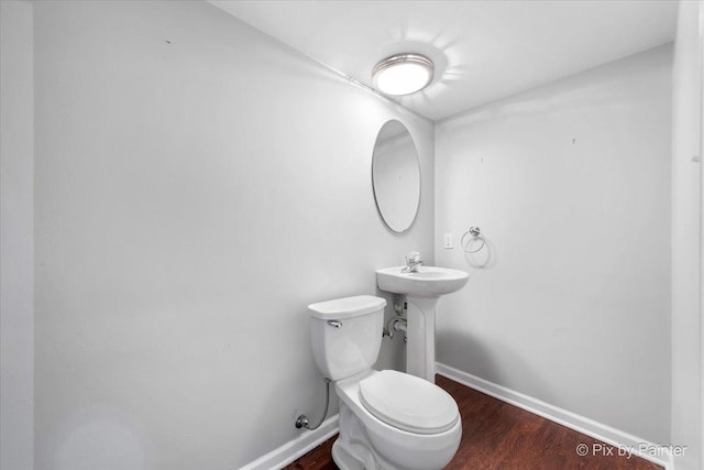 18104 Lake Shore Dr, Orland Park, IL 60467 - half bathroom with wood finished floors, toilet, and baseboards